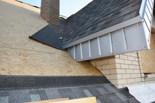 Halfway replaced roof of house